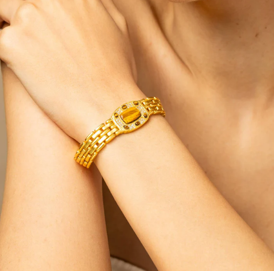 18k gold-finish oval tiger’s eye bracelet on wrist, minimalist unisex statement jewelry