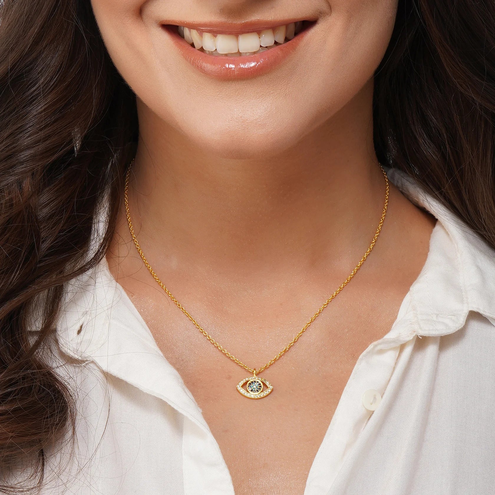 woman wearing gold-plated evil eye necklace with cz crystals, minimalist protective jewelry for daily style