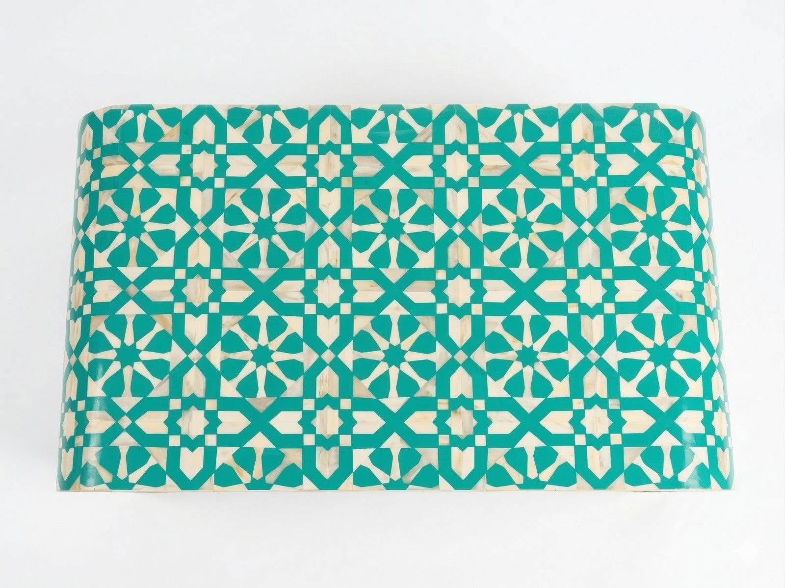 Teal and beige patterned mat on a white background