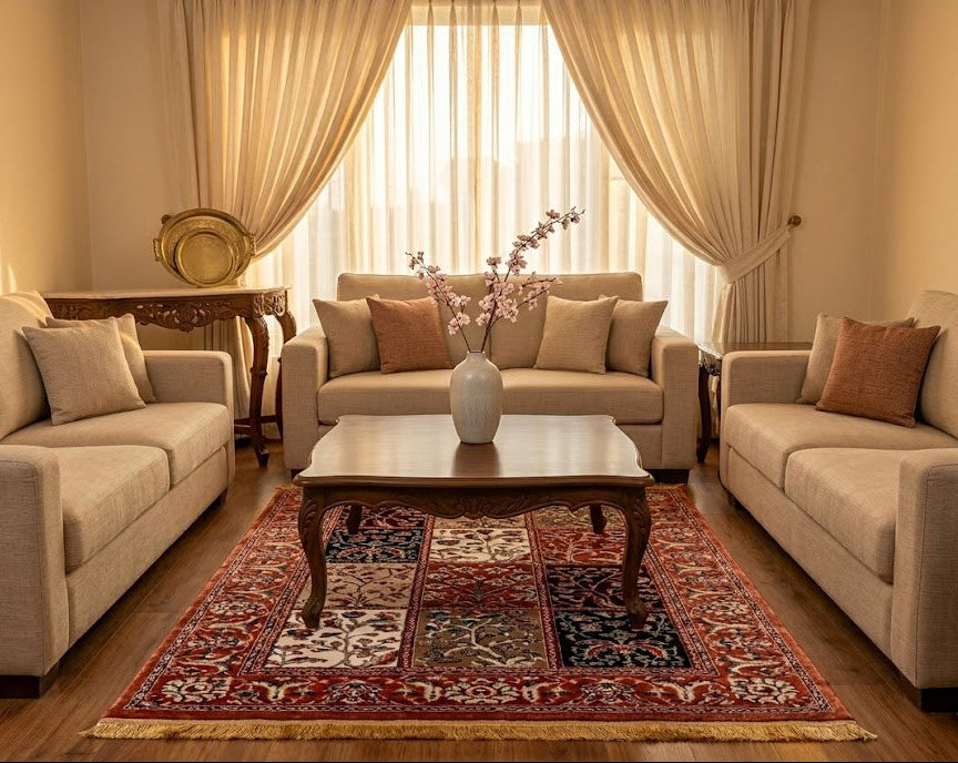 Living room with beige sofas, a coffee table, and a decorative rug.