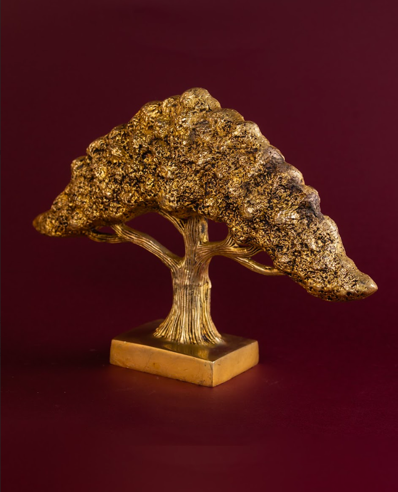 Side profile of brass Banyan Tree of Life sculpture showing layered branches and canopy depth