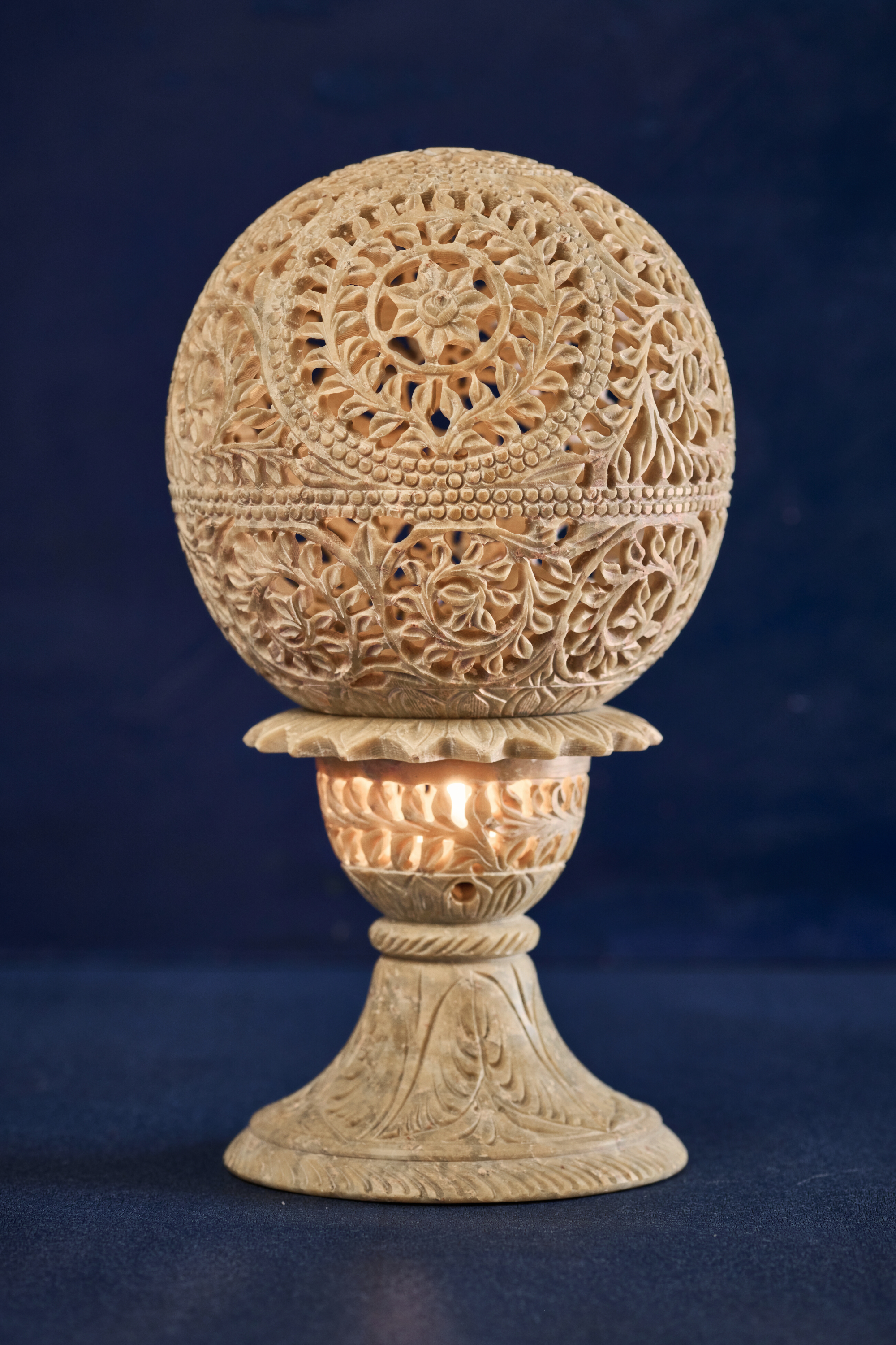 Beige stone intricate lampshade handcrafted with detailed carving, designed to create warm and elegant ambient lighting