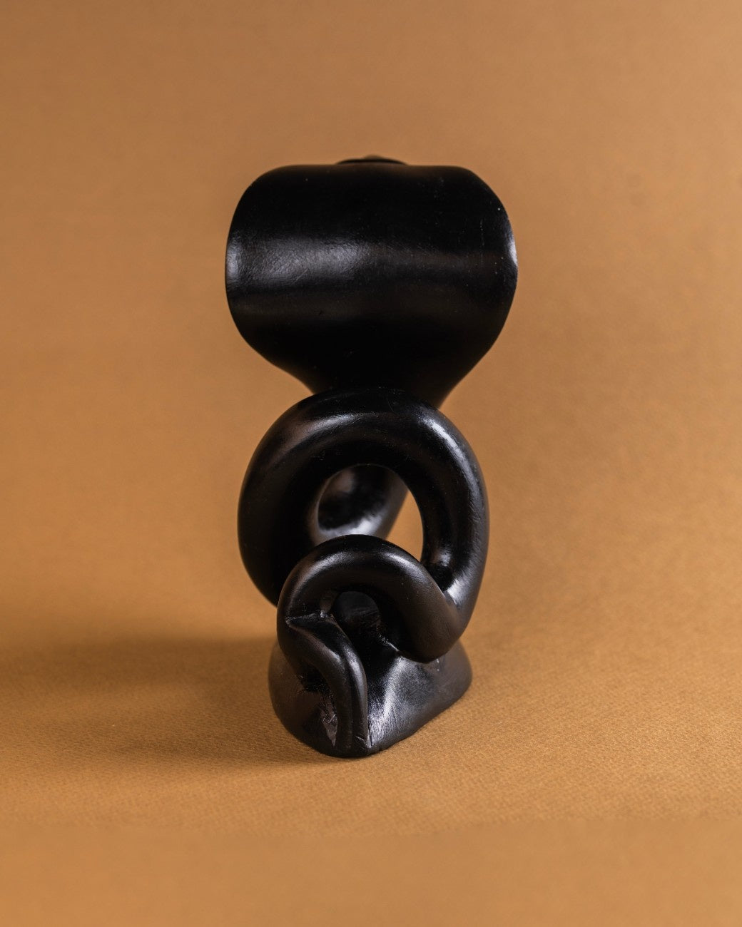 Compact black stone cobra sculpture carved from solid stone
