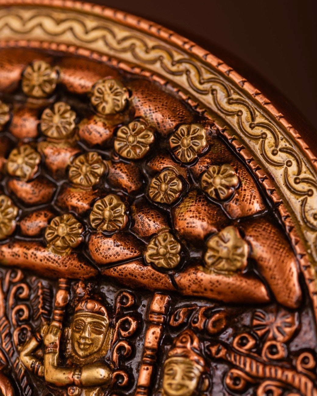 Detailed view of hand-hammered brass and copper surface work