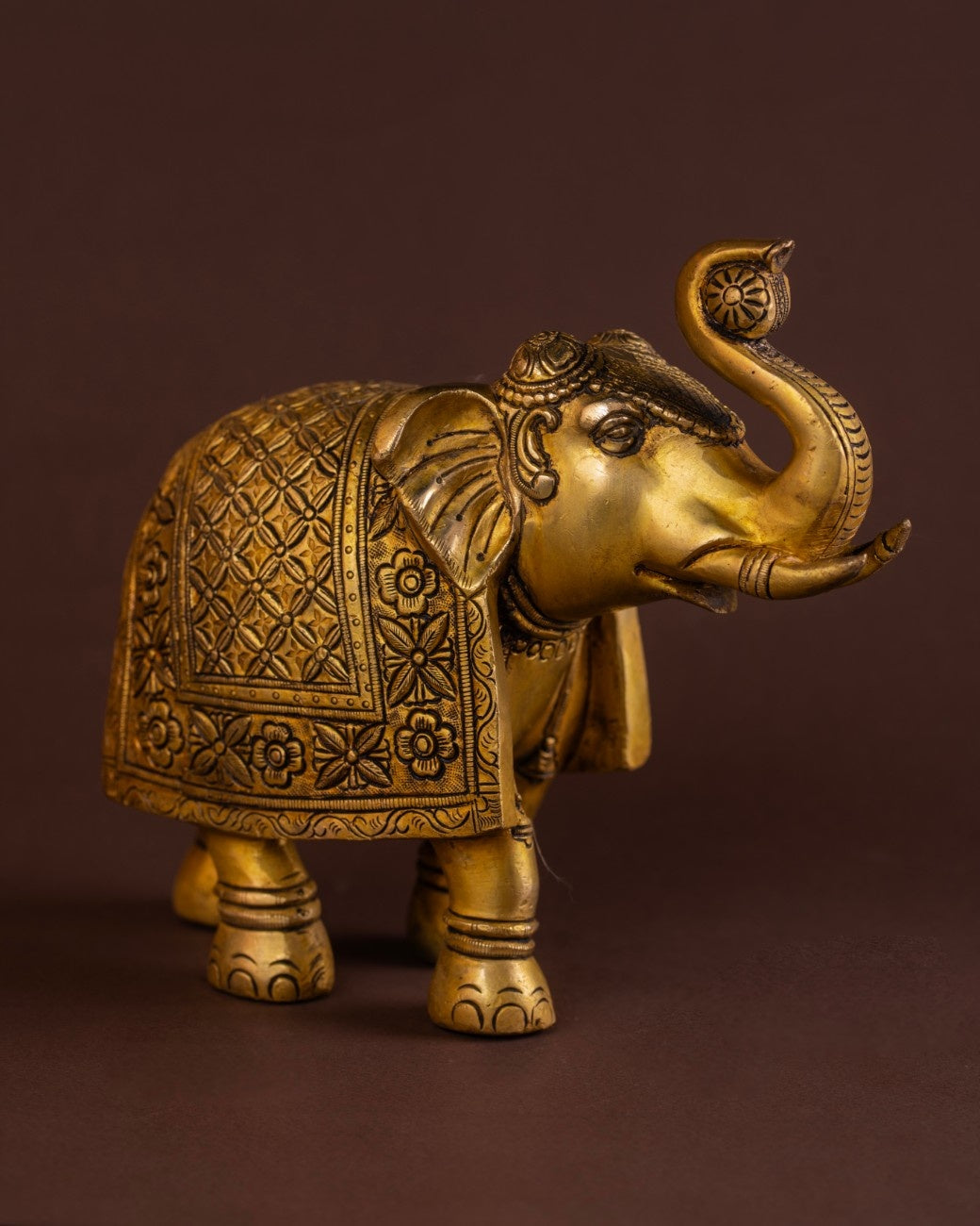 Engraved brass elephant statue with traditional patterns