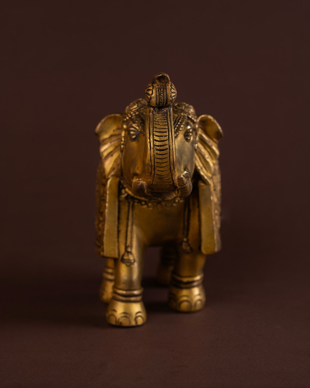Engraved brass elephant statue with traditional patterns