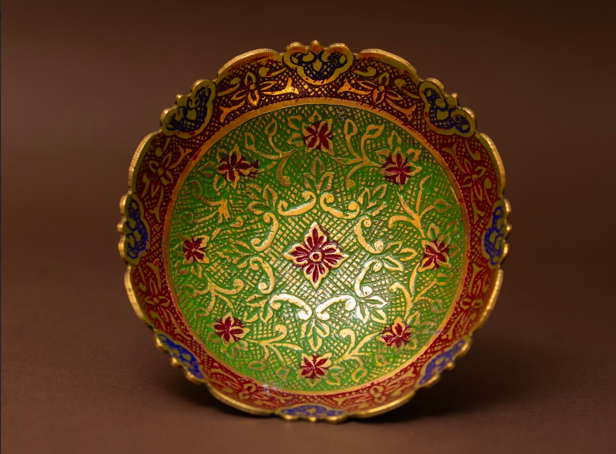 Handcrafted brass fruit bowl with green enamel floral detailing