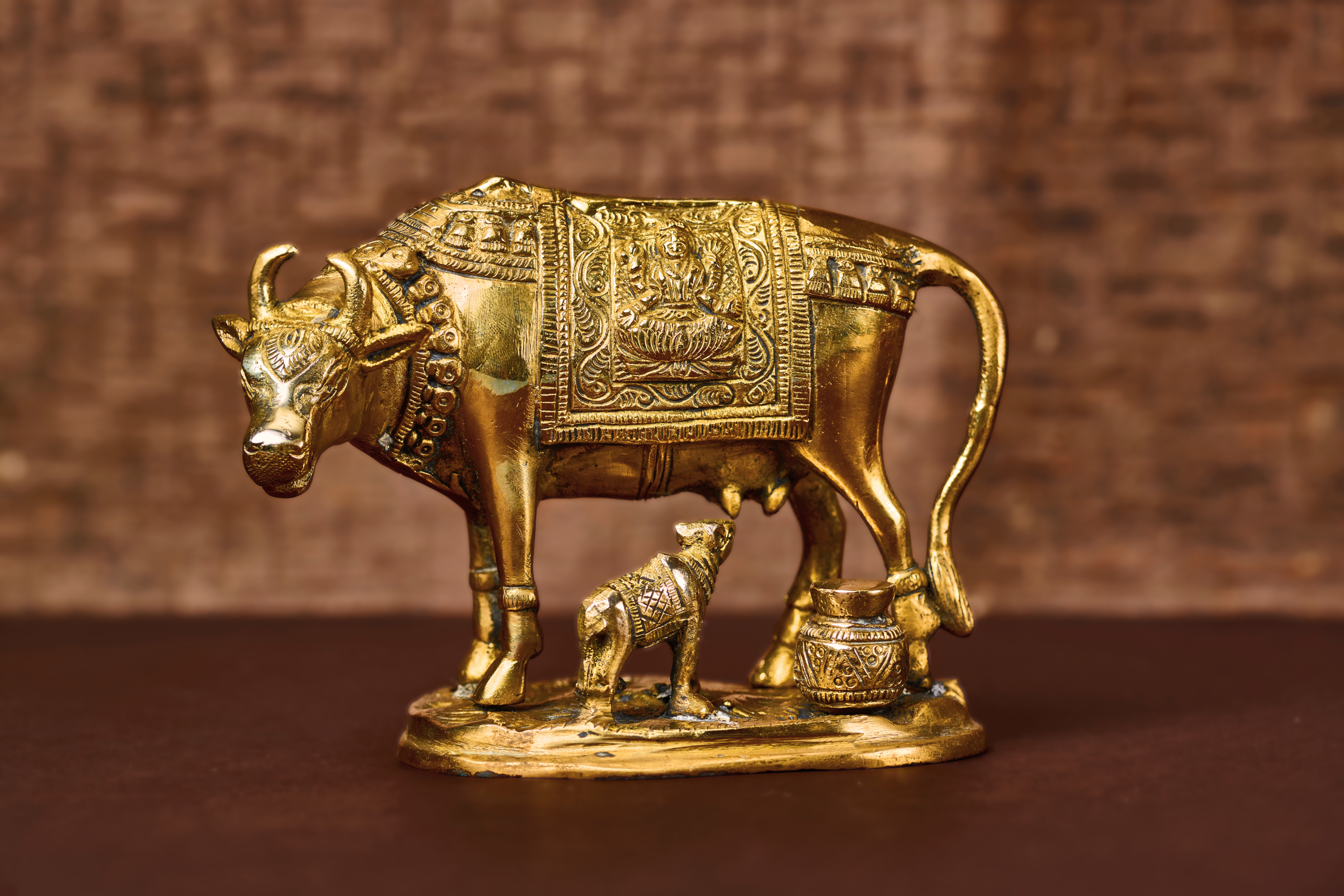 Indian brass statue of Kamadhenu divine cow with calf – traditional brass sculpture symbolising abundance