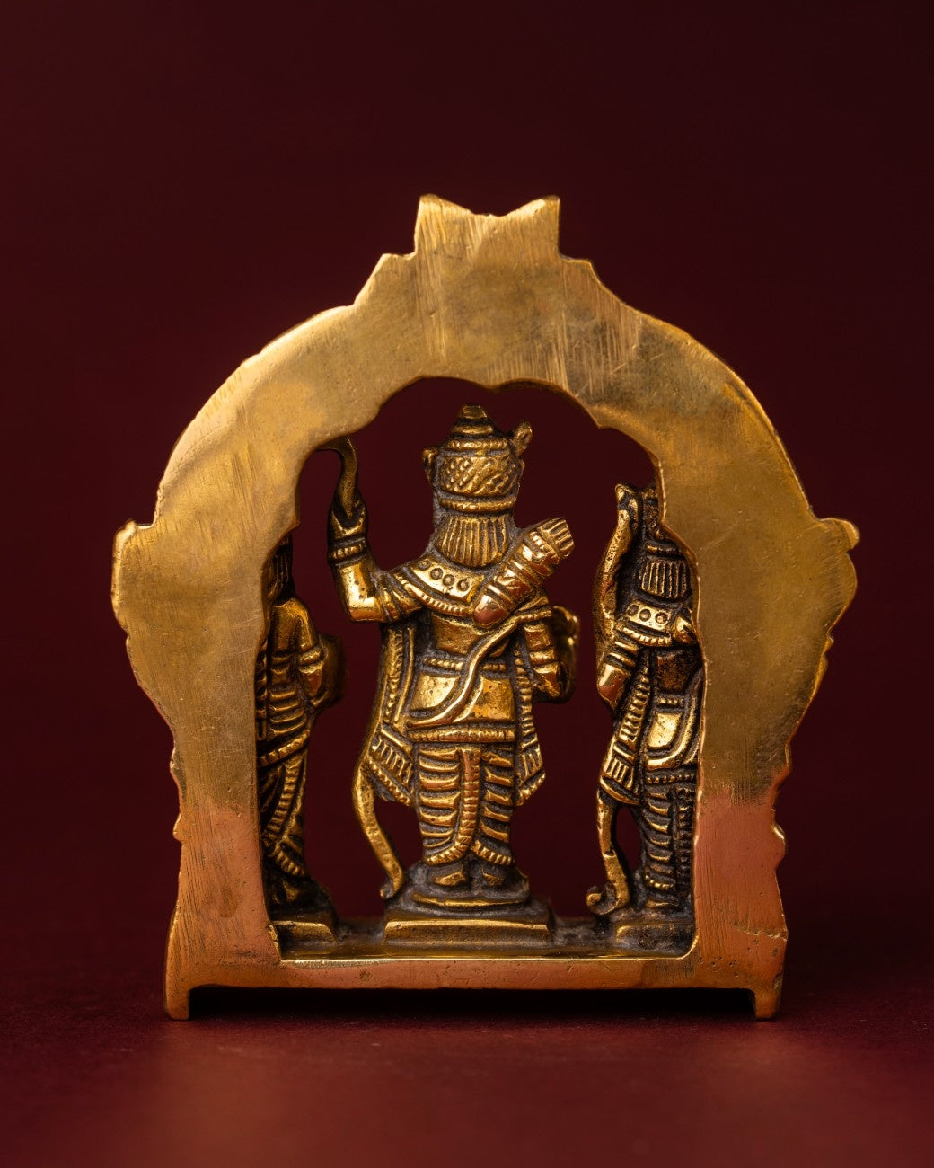 Back view of brass Ram Darbar statue showing carved arch detailing and handcrafted metal texture.