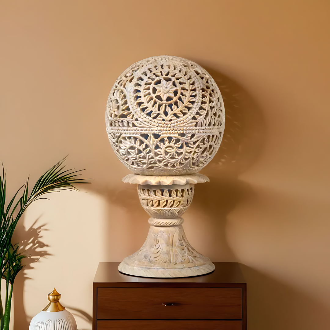 Intricately carved beige stone lampshade showcasing traditional craftsmanship and soft, soothing illumination