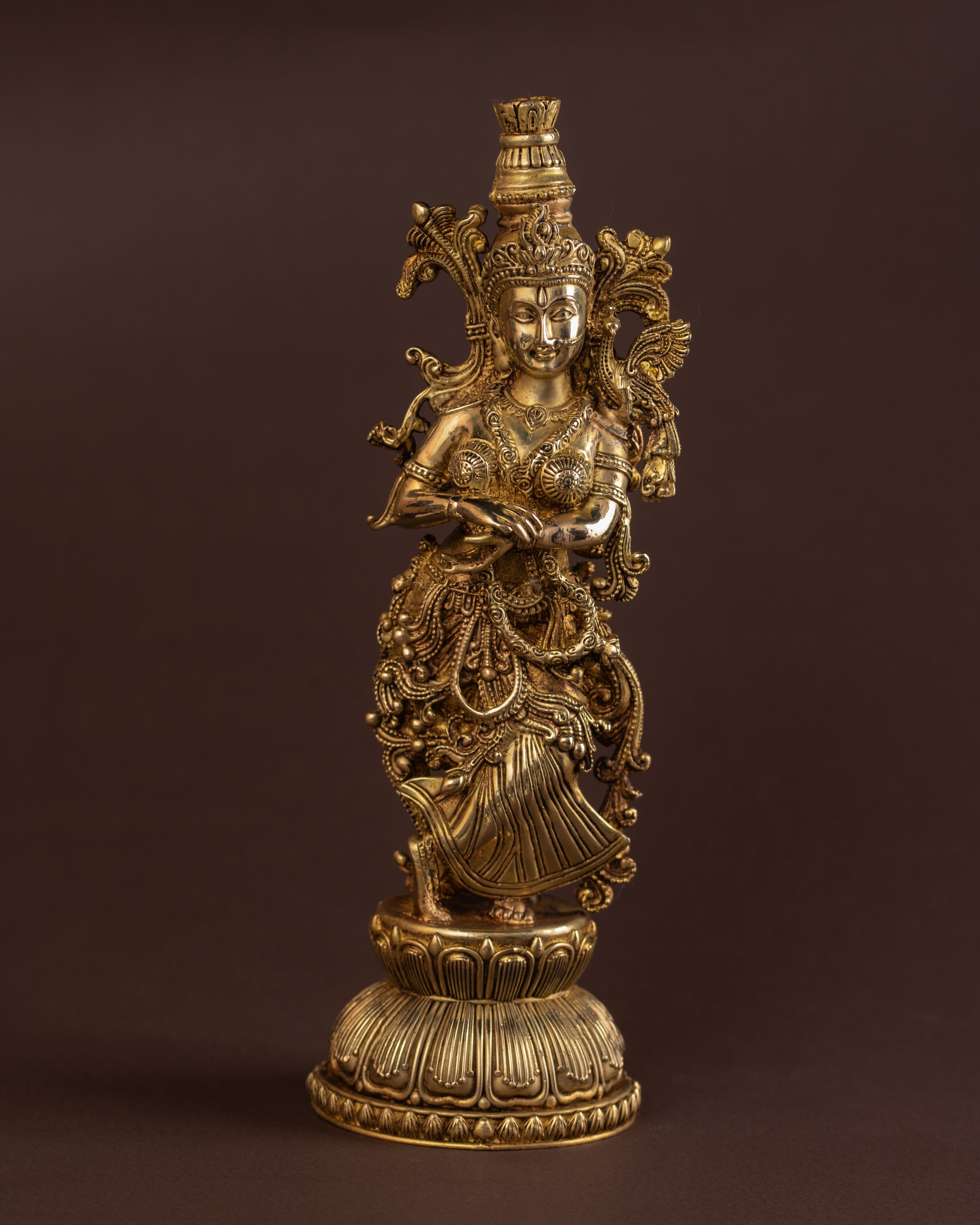 Brass Radha statue in full standing pose with ornate jewellery and carved detailing, traditional Hindu deity sculpture.