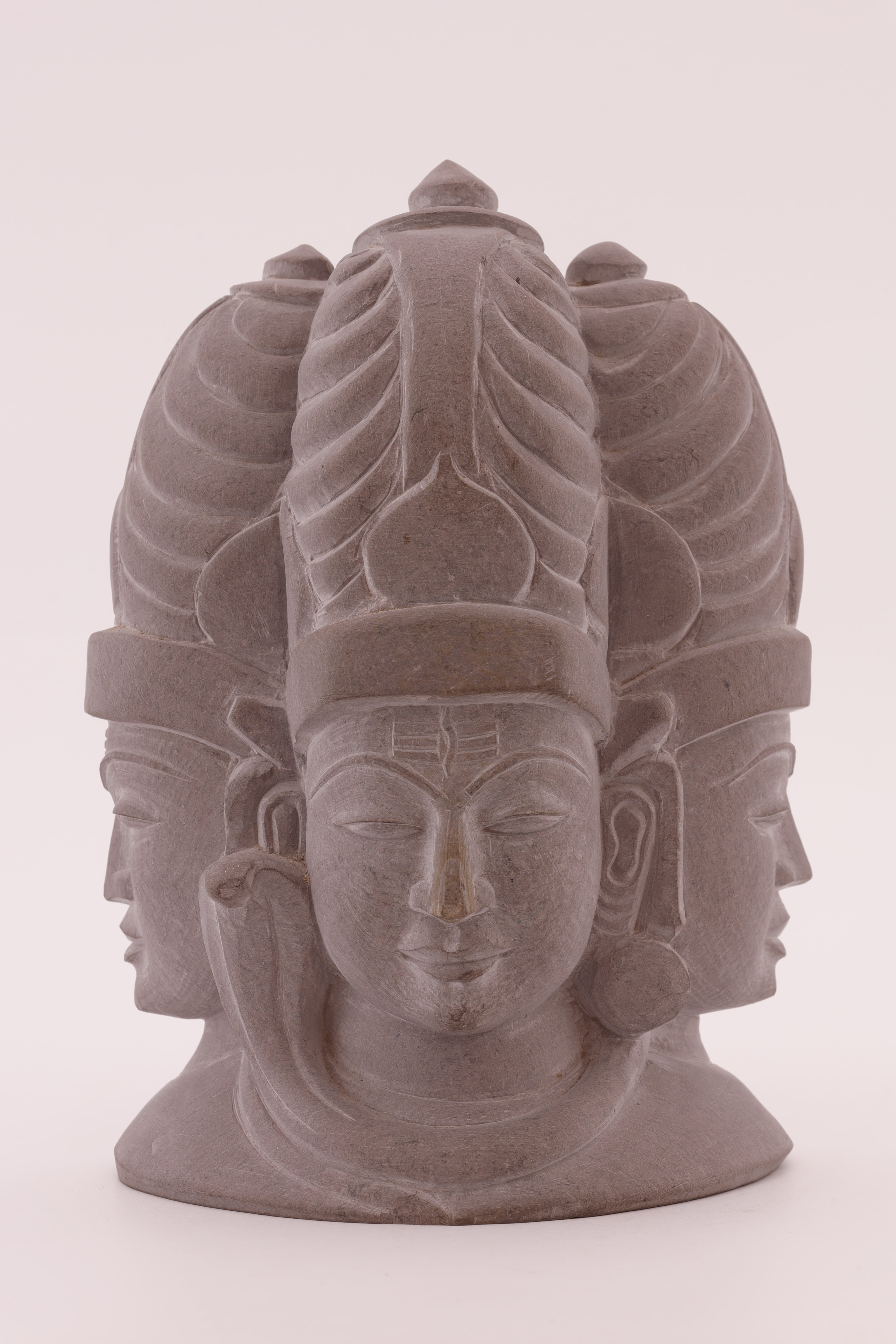 Lord Shiva trinity stone sculpture featuring intricate detailing and a powerful spiritual presence for devotional interiors