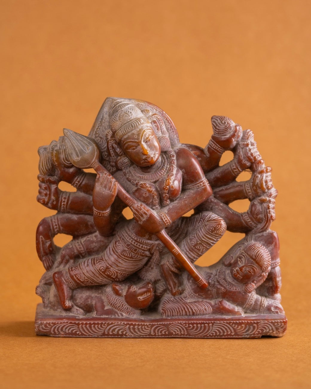 Hand-carved red stone idol of Goddess Kali representing sacred divine power