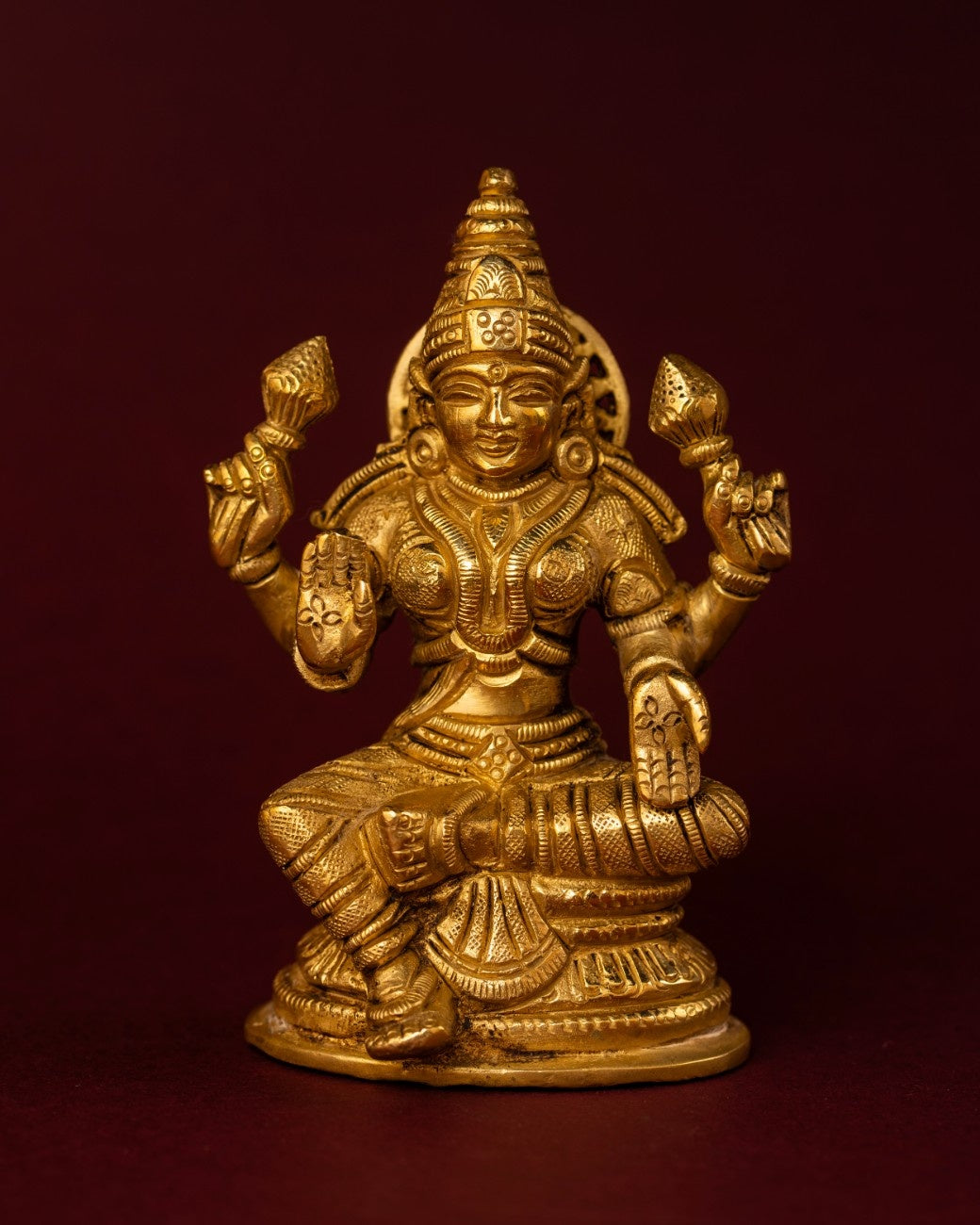 Handcrafted Indian brass statue of Goddess Lakshmi seated on a lotus – detailed brass sculpture for home décor.