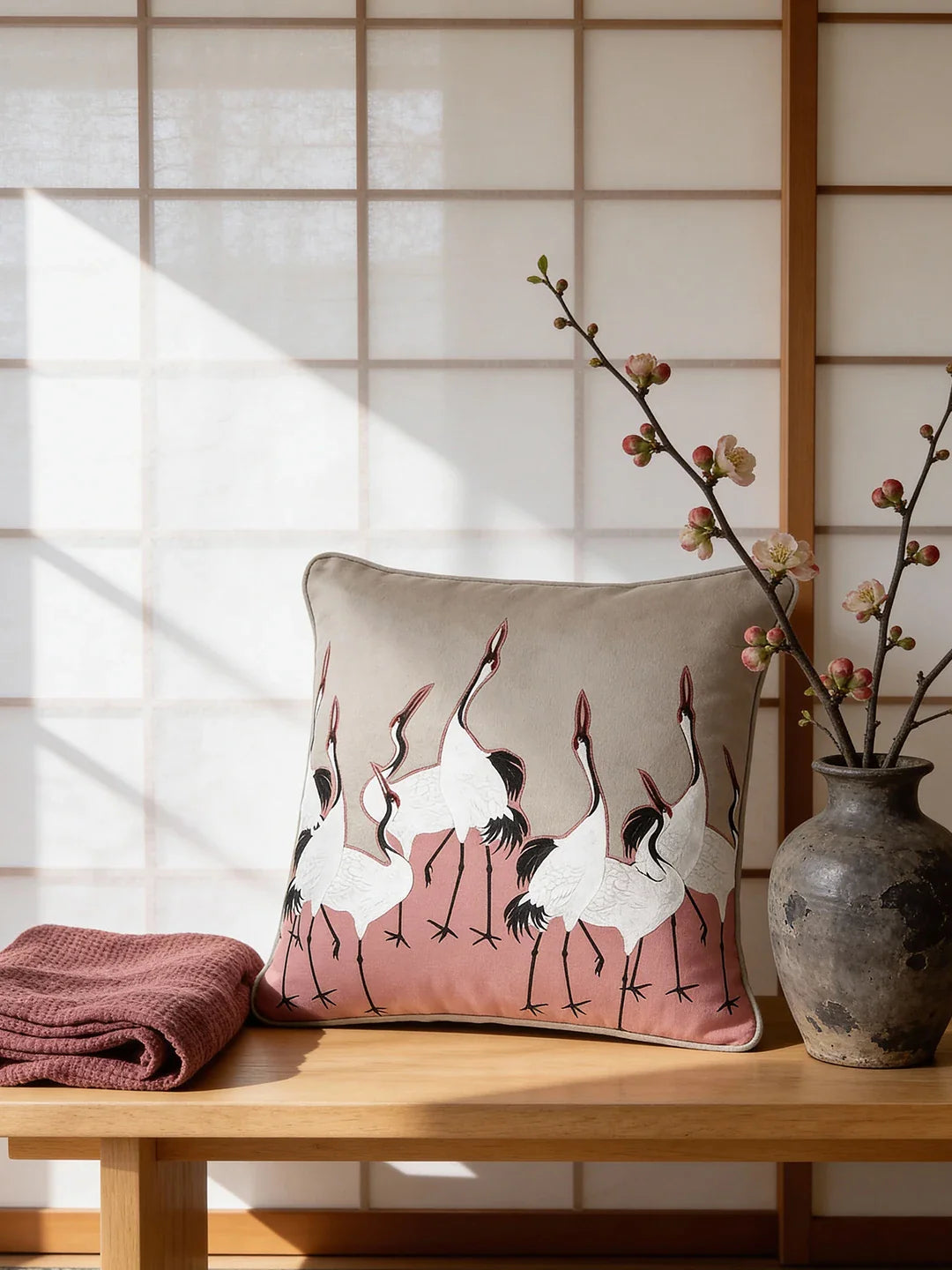 Front view of the Sedge Pink cushion cover featuring hand-embroidered white cranes on a pink and grey velvet background.