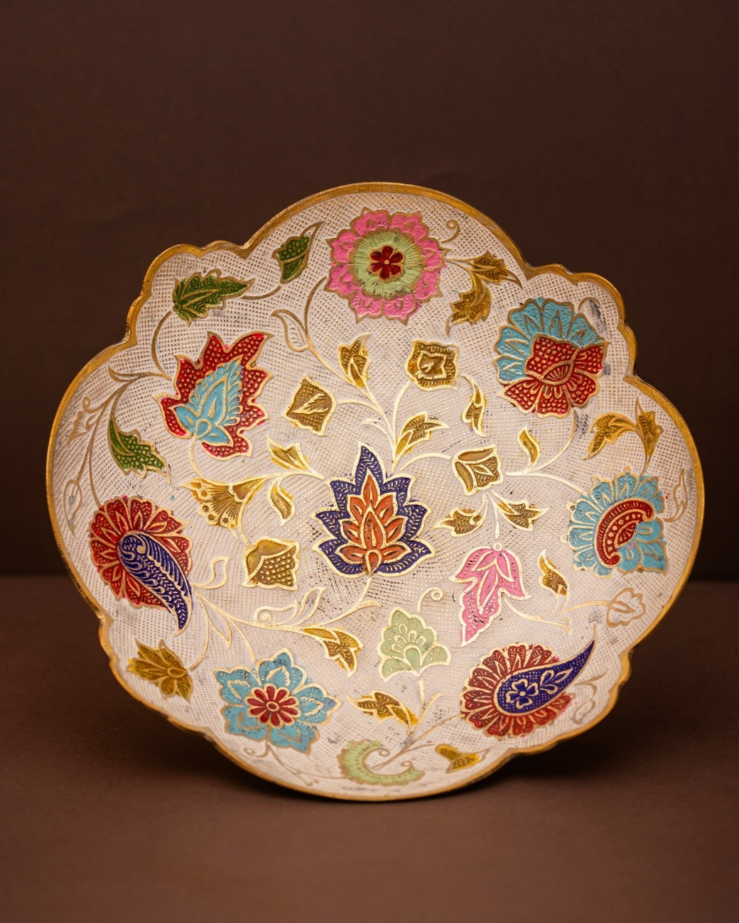 Decorative plate with floral and paisley patterns 